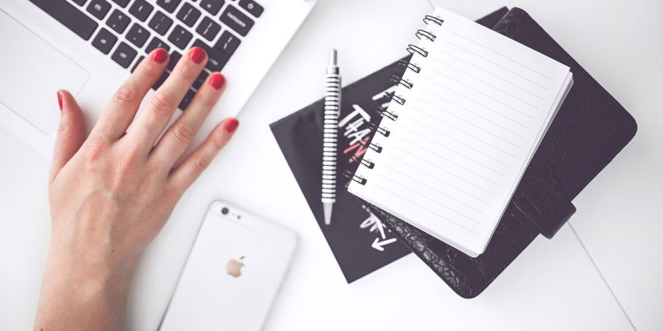 woman-hand-smartphone-desk